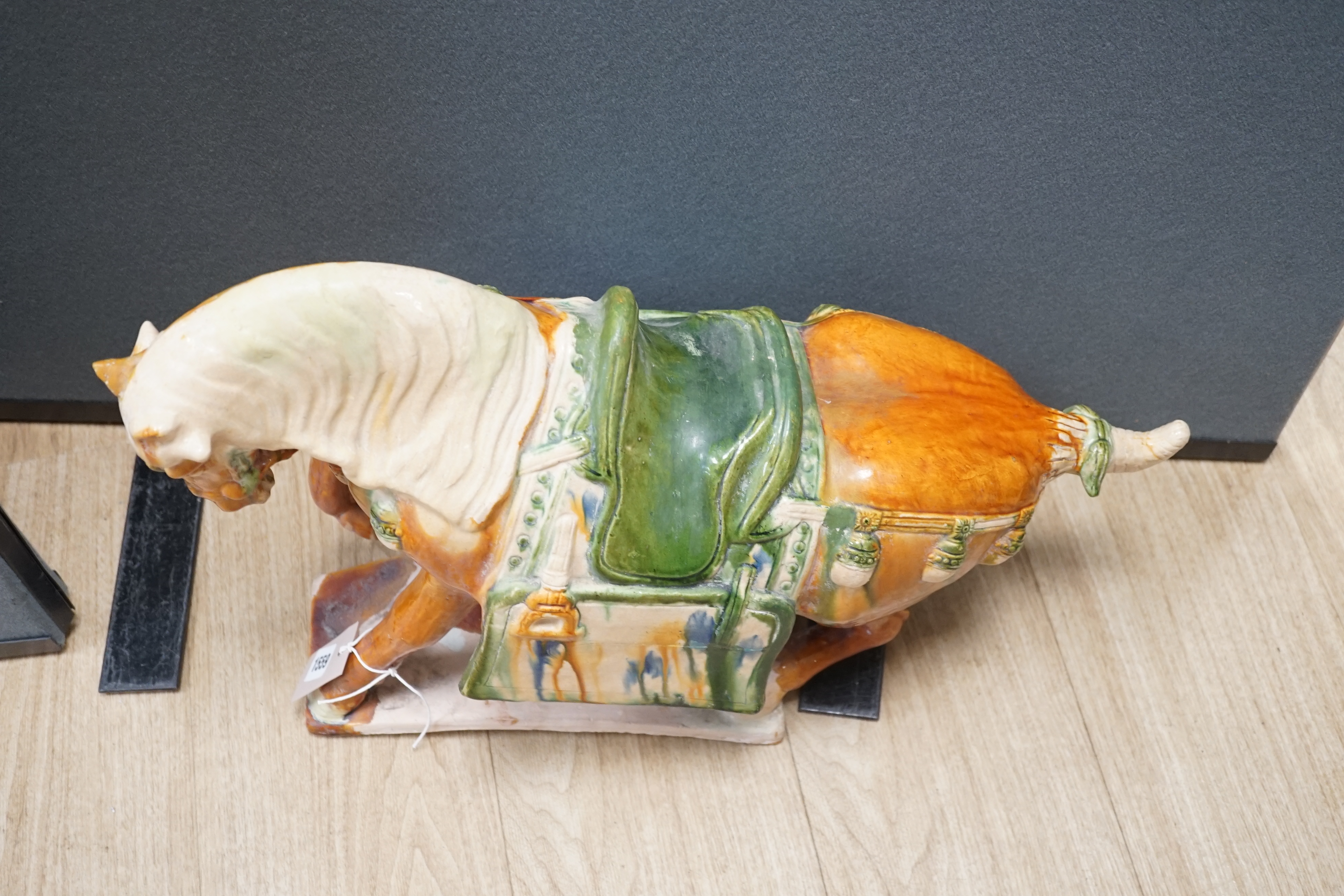 A large Chinese Tang-style pottery model of a tomb horse, 54cm long